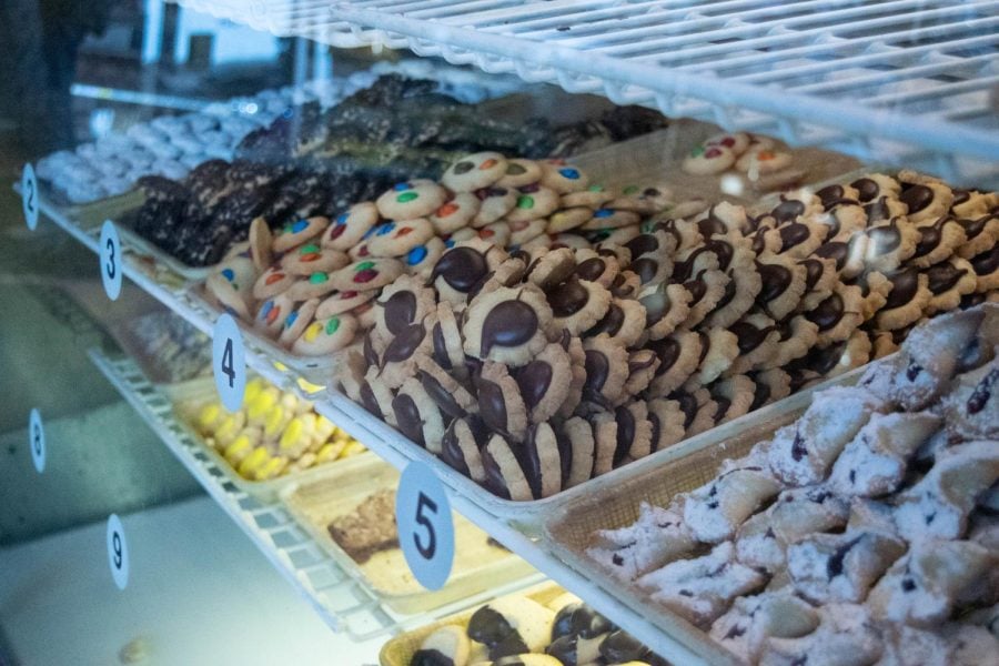 A variety of cookies is displayed in a display case in the bakery