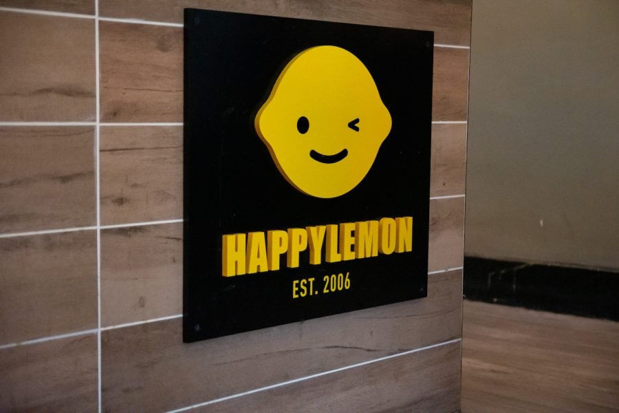 Happy Lemon sign. Features a yellow lemon winking above Happy Lemon, which is above Est. 2006.