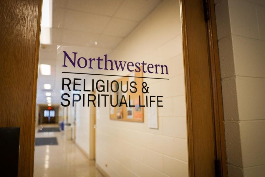 The words “Northwestern: Religious & Spiritual Life” are written on a door’s glass in Parkes Hall.