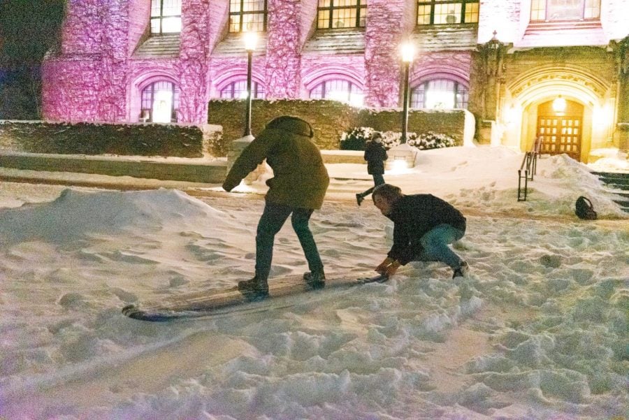 Northwestern students play with the snow in front of Deering Library.