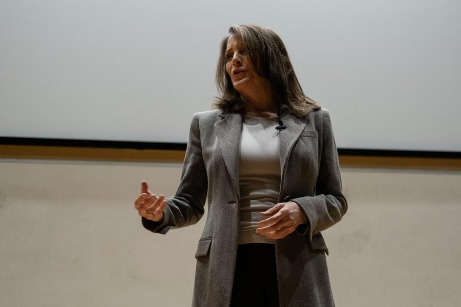 Marianne Williamson stands onstage at Lutkin Hall.