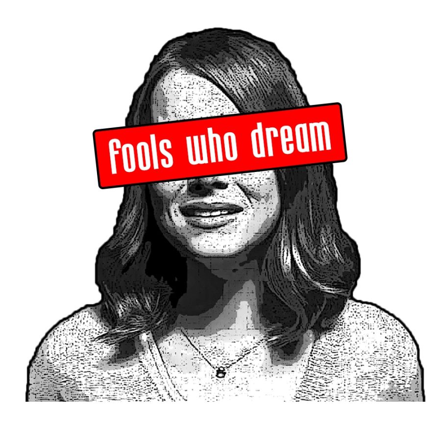 A woman with shoulder-length hair. Over her eyes is a red rectangle with white letters reading “fools who dream.”