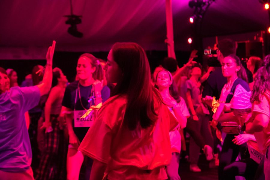 Students dance in a tent.