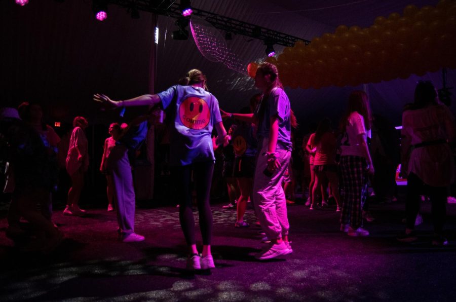 Students dance in a tent.