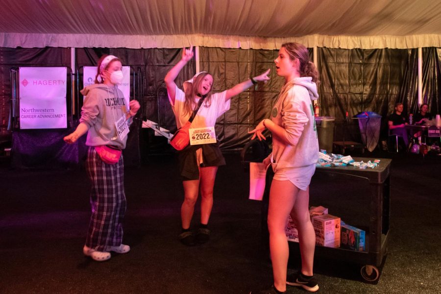 Students dance with the music in a tent.