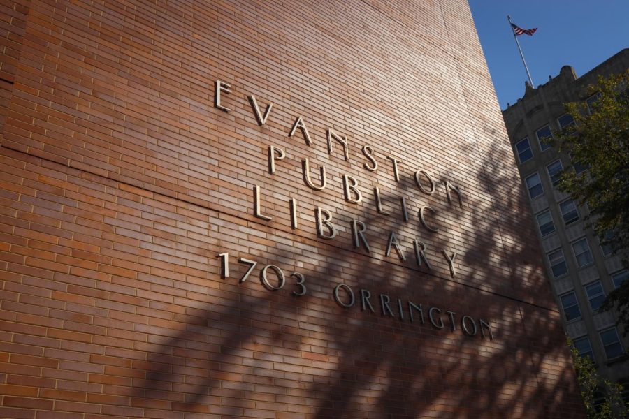 The Evanston public library sign, gold lettering on a red-brick building.