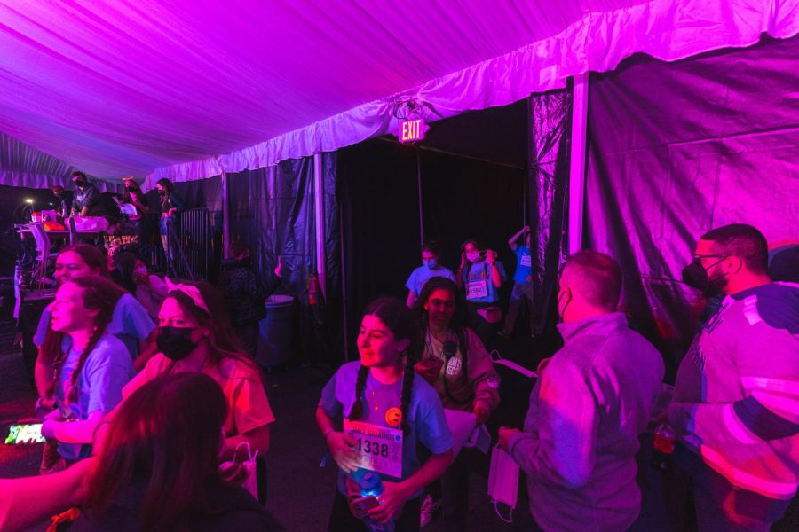 Students walk into a tent filled with lights and music