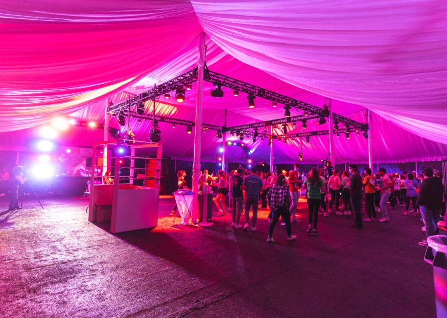 Students dance in a tent with lights and music