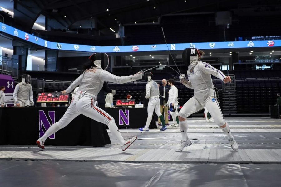 A fencer in a white suit faces off