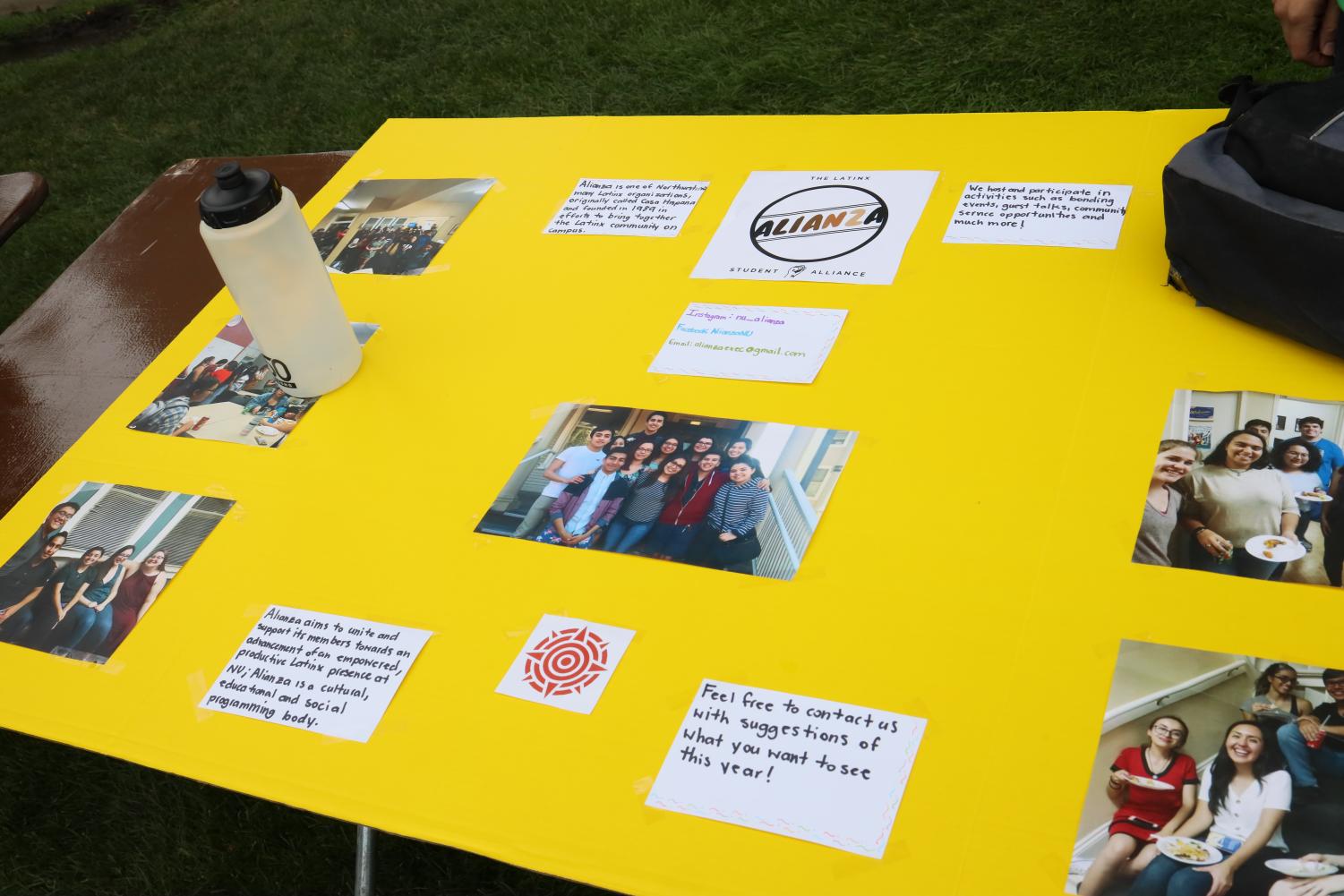 A+Yellow+tri-fold+poster+board+with+pre-coronavirus+photos+and+text+about+Alianza.