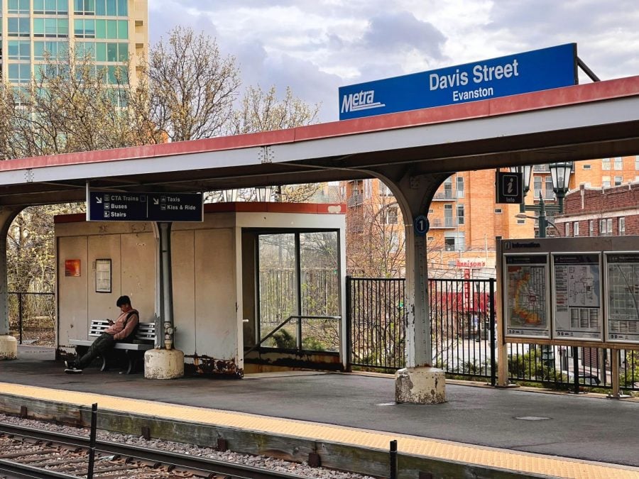 Evanston Davis Street Metra station platform with one person sitting on a bench.