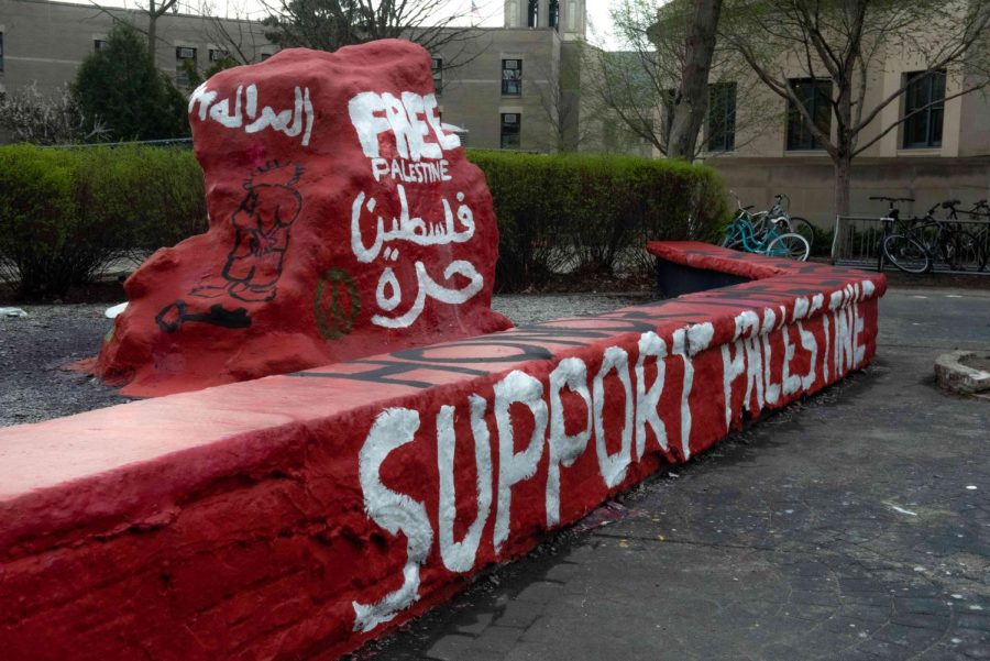 The Rock, painted red with white text that reads “Free Palestine” in English and Arabic.