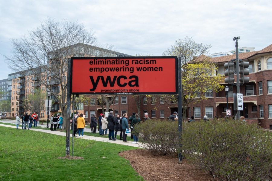 An orange sign with black letters reads “eliminating racism, empowering women YWCA Evanston/ North Shore.”