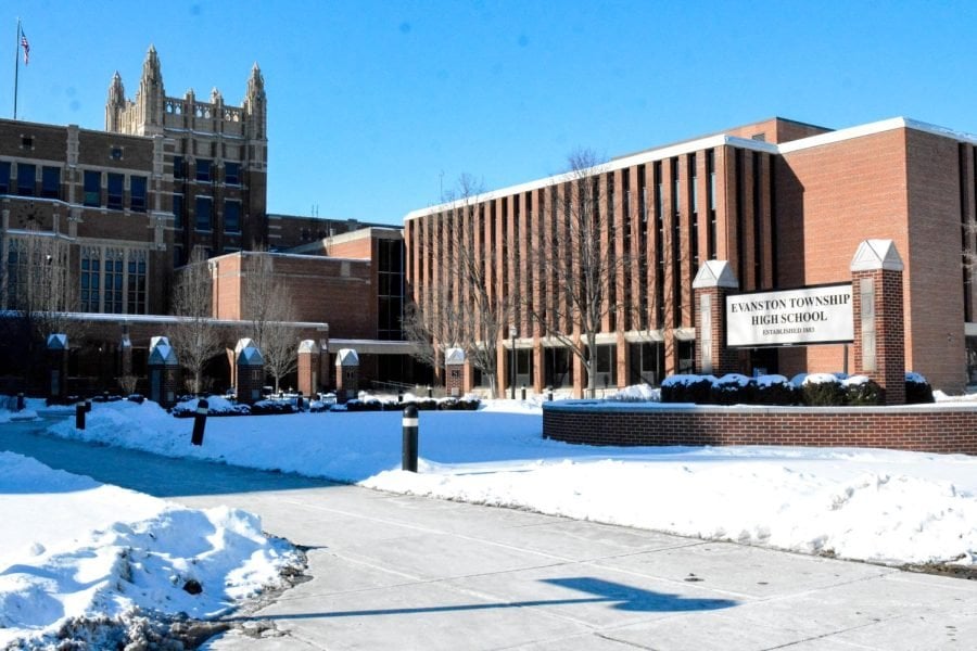 The front of Evanston Township High School. Snow covers the ground and the sky is clear.