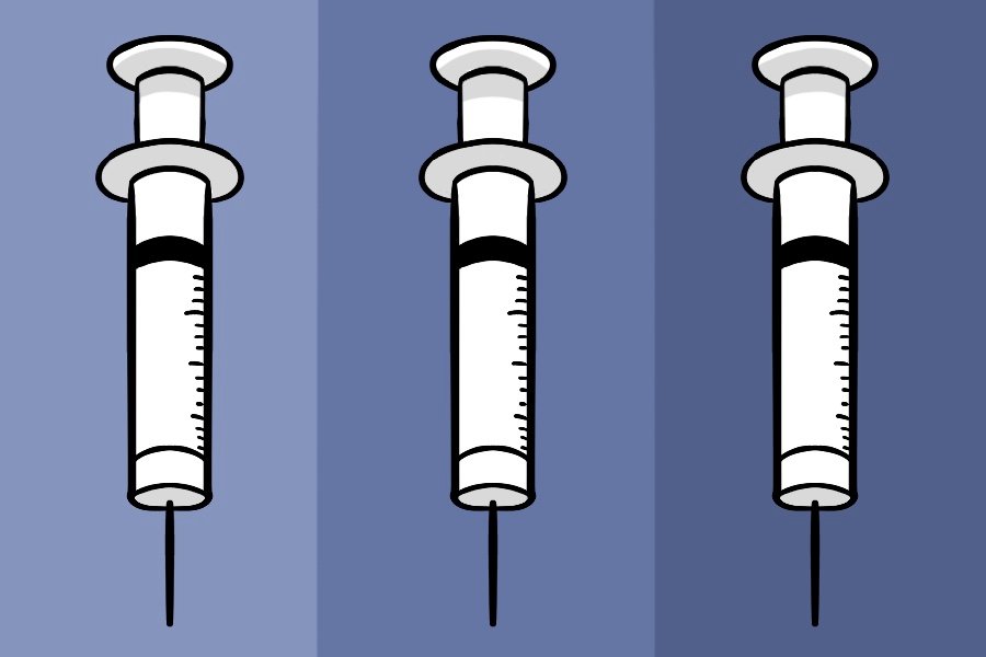 Three vaccine needles positioned vertically on various shades of blue.
