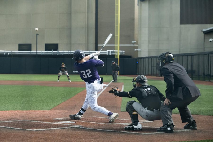 Player+in+purple+jersey+takes+a+big+swing.