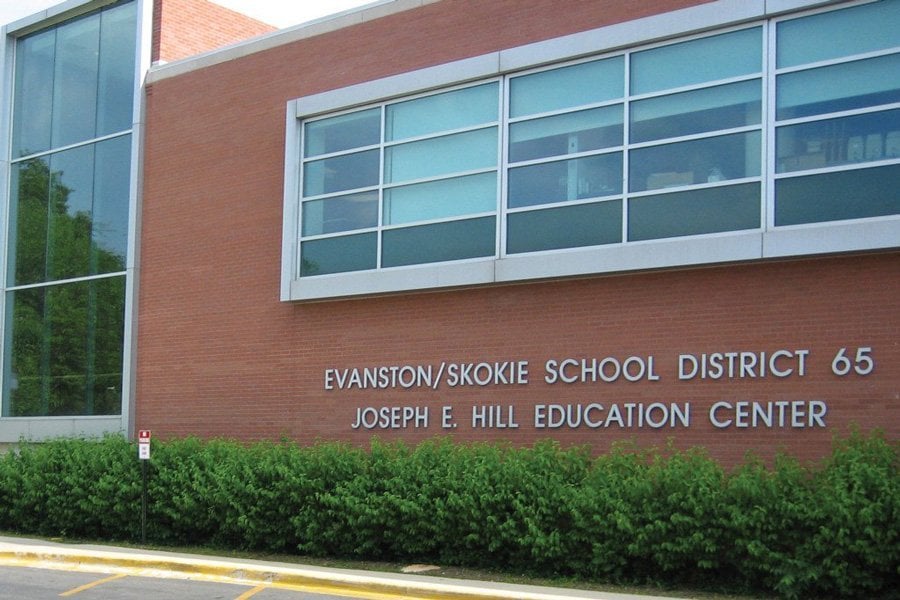The Evanston/Skokie School District 65 Education Center. The building is red brick with blue glass windows.