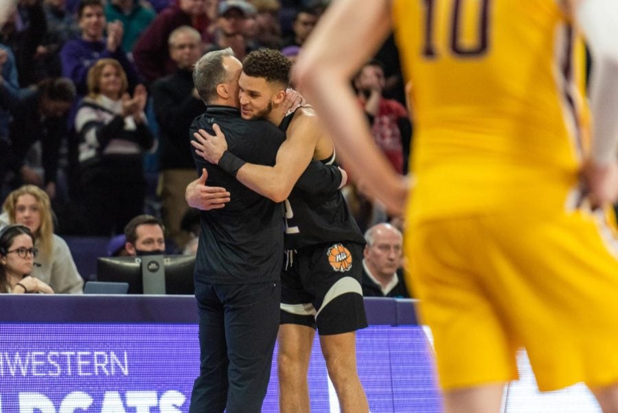 Pete Nance hugs coach Chris Collins in his final home game for Northwestern. Nance announced his transfer to UNC on Saturday.