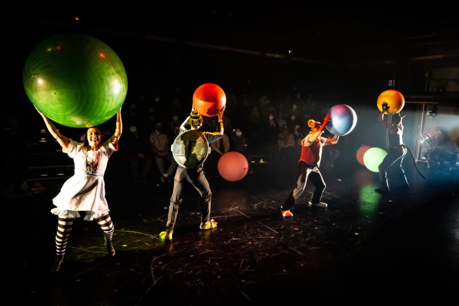 Four+people+hold+colorful+fitness+balls+while+moving