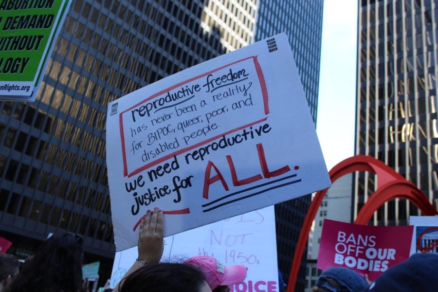 Protest sign reads, “Reproductive freedom has never been a reality for BIPOC, queer, poor, and disabled people. We need reproductive justice for ALL.”