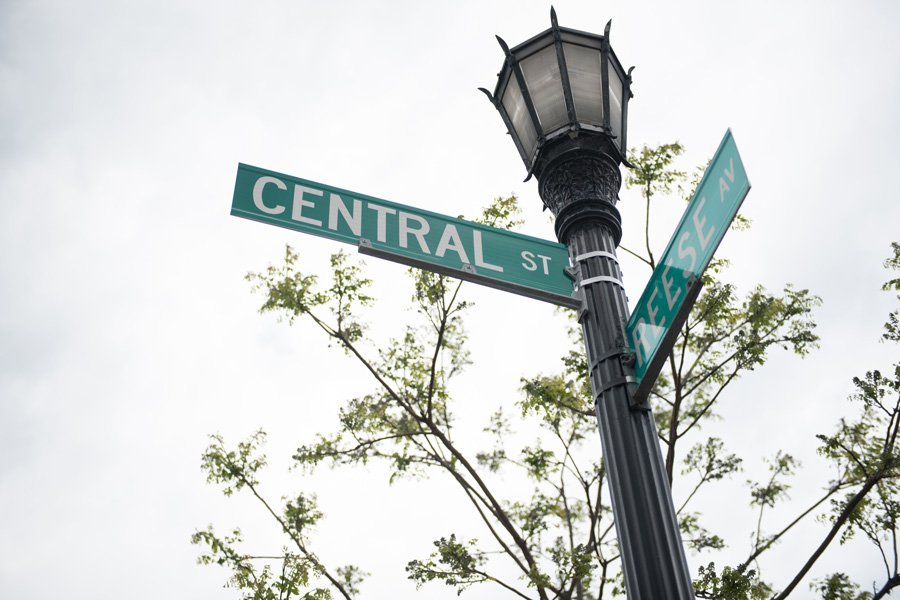 A street lamp with two green street signs at an intersection.