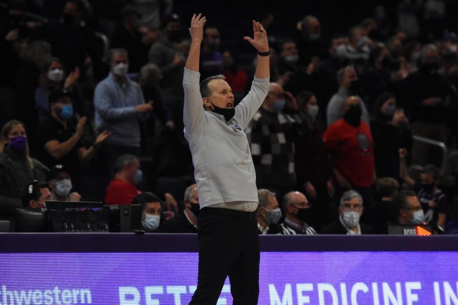 A basketball coach throws his hands in the air.