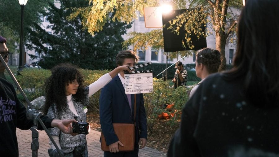 One person is holding the clapperboard in front of two actors right before the scene.