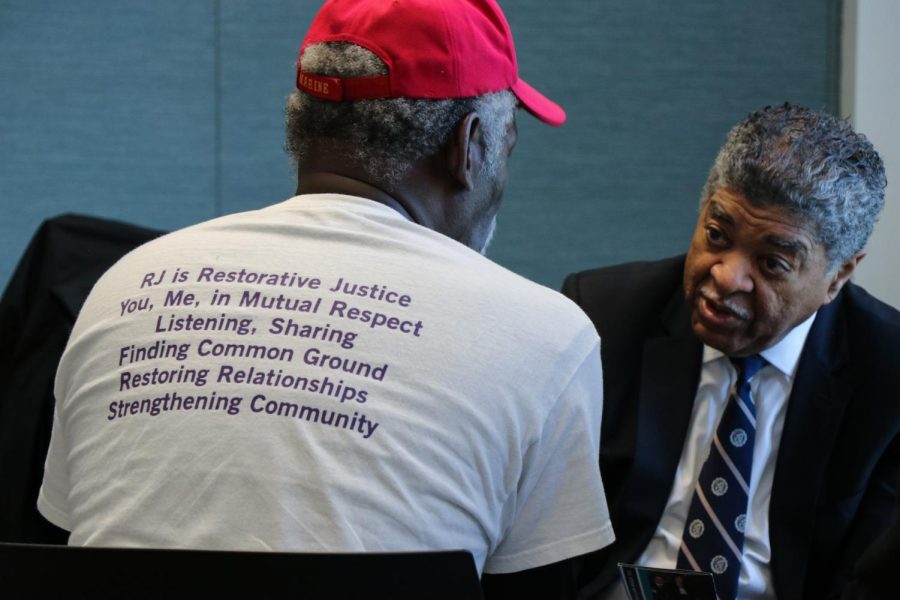 A person with a restorative justice t-shirt speaks to a judge.