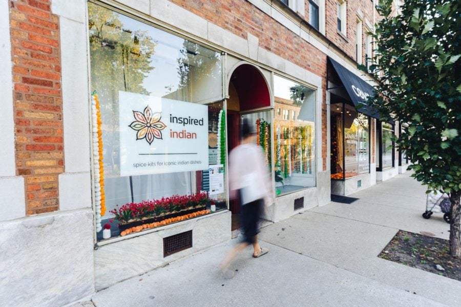 A woman walks in front of Inspired Indian, a shop in downtown Evanston.