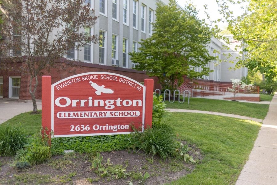 An image of a red sign sitting outside Orrington Elementary School reads “Evanston Skokie School District Orrington Elementary School.”