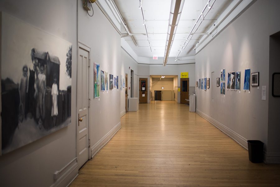 A large hallway with art hung up on the wall