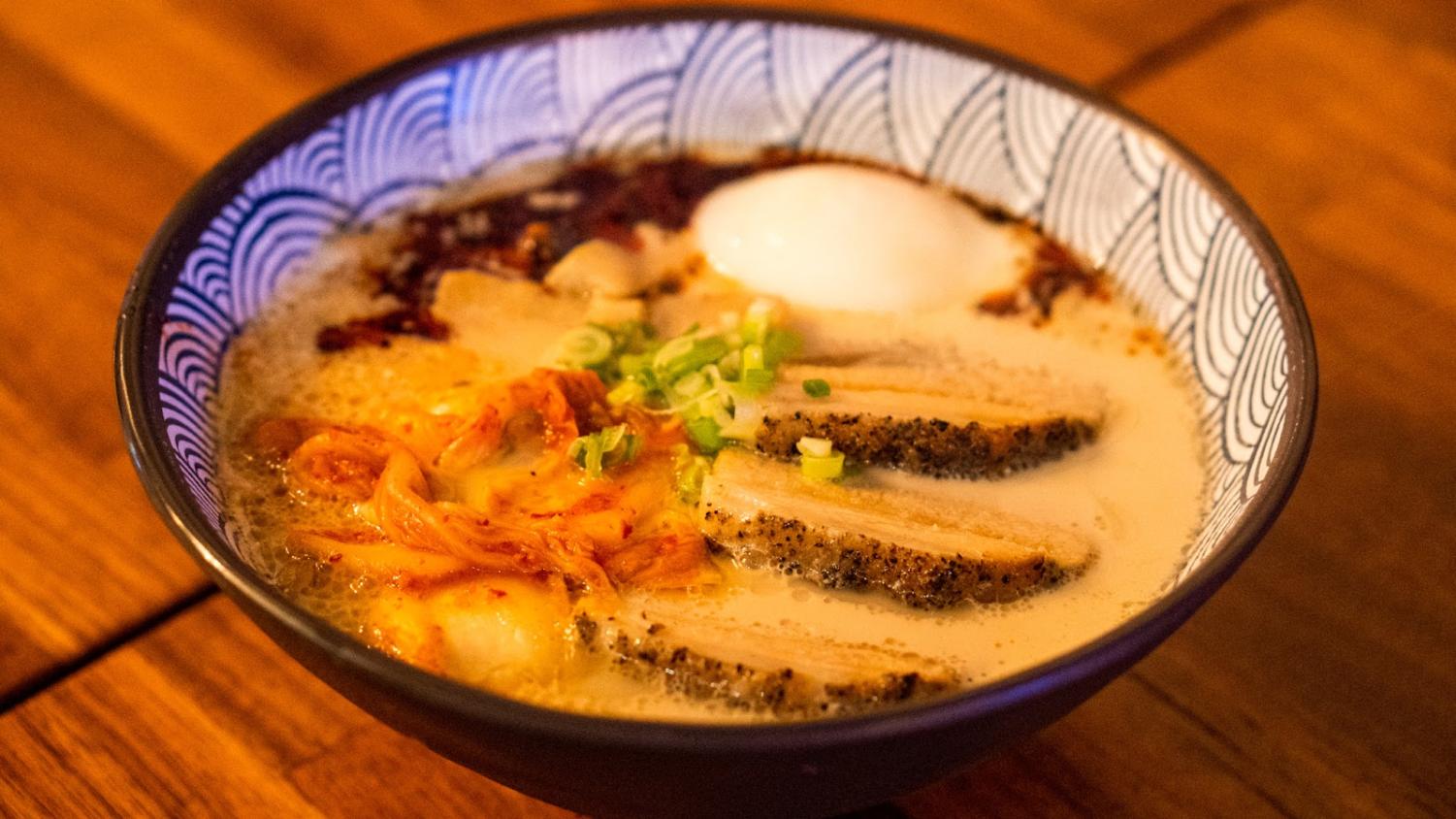 A bowl of ramen on a wooden table.