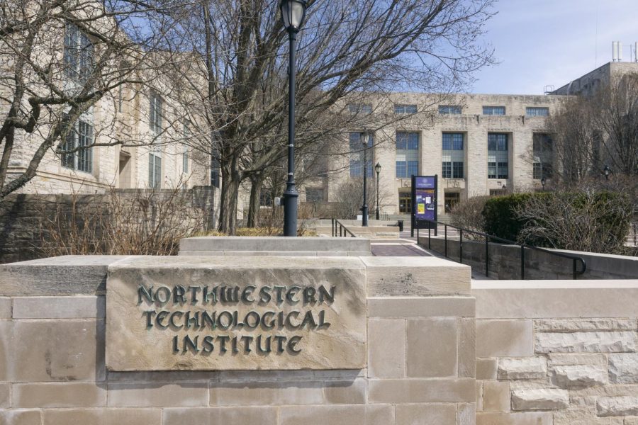A sign that reads “Northwestern Technological Institute” with trees and a large building behind it.