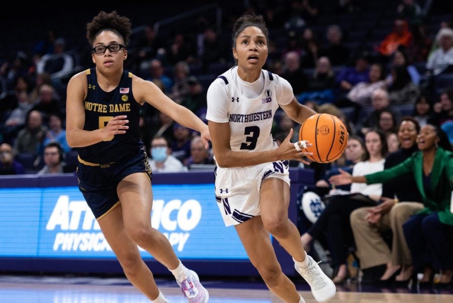 Senior guard Laya Hartman advances the ball across the court.