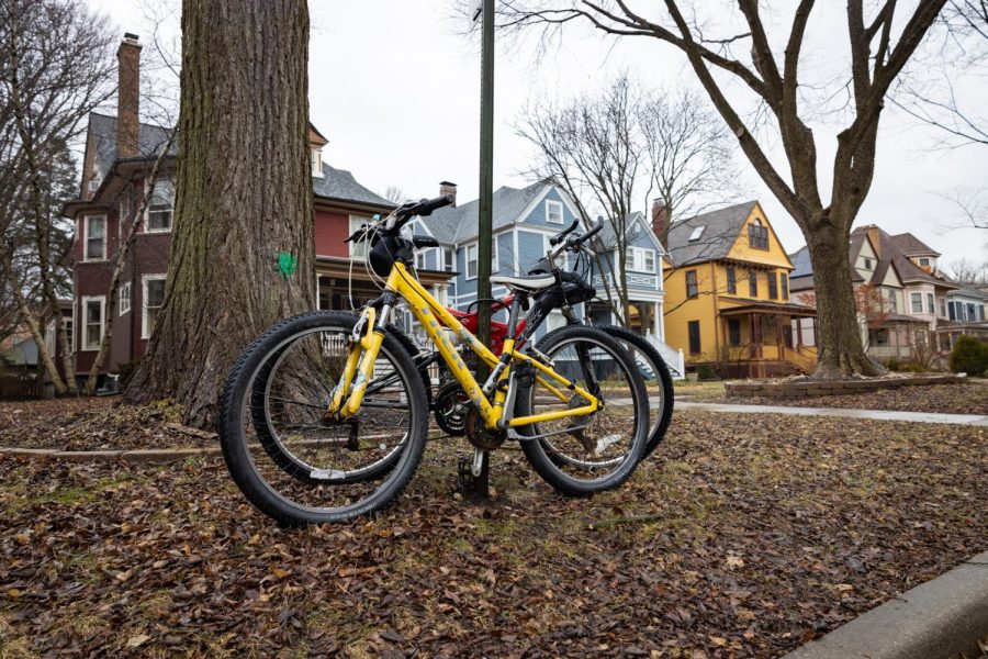 Yellow bikes sit in front of colorful houses.