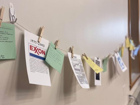 Papers line the wall on a clothesline to represent a climate timeline