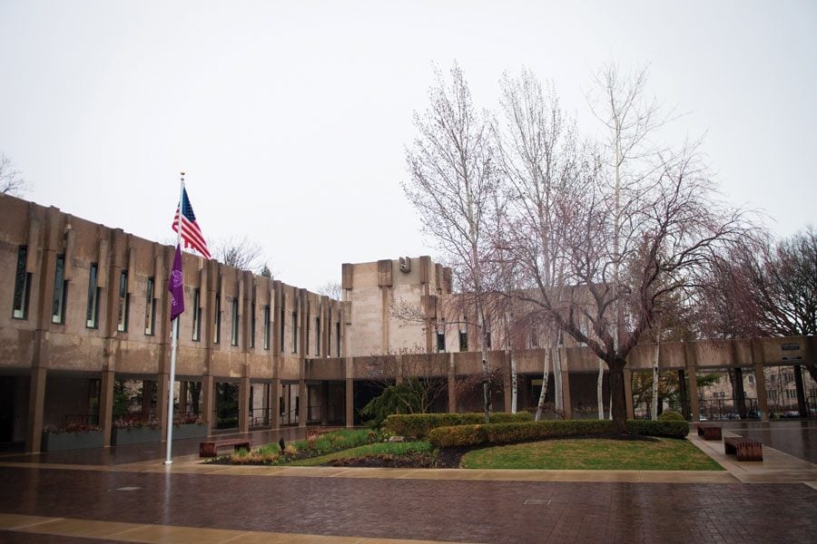 Building with a U.S. and purple Northwestern flag in front.