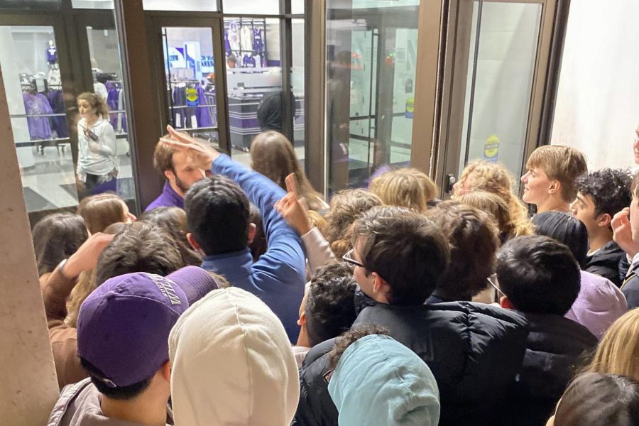 A group of students blocked from the entrance of WelshRyan Arena by an arena worker.