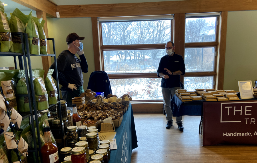 Stefan Markov of The Naked Truffle and Todd Allison of River Valley Ranch and Kitchens converse beside their tables, containing, respectively, truffles and mushrooms.