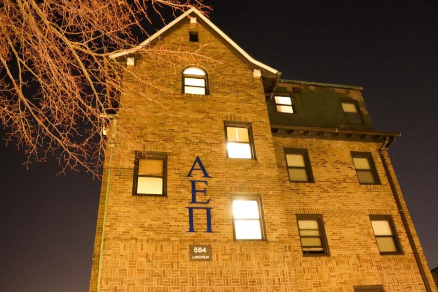 Brown house with the Greek letters AEPi written vertically.