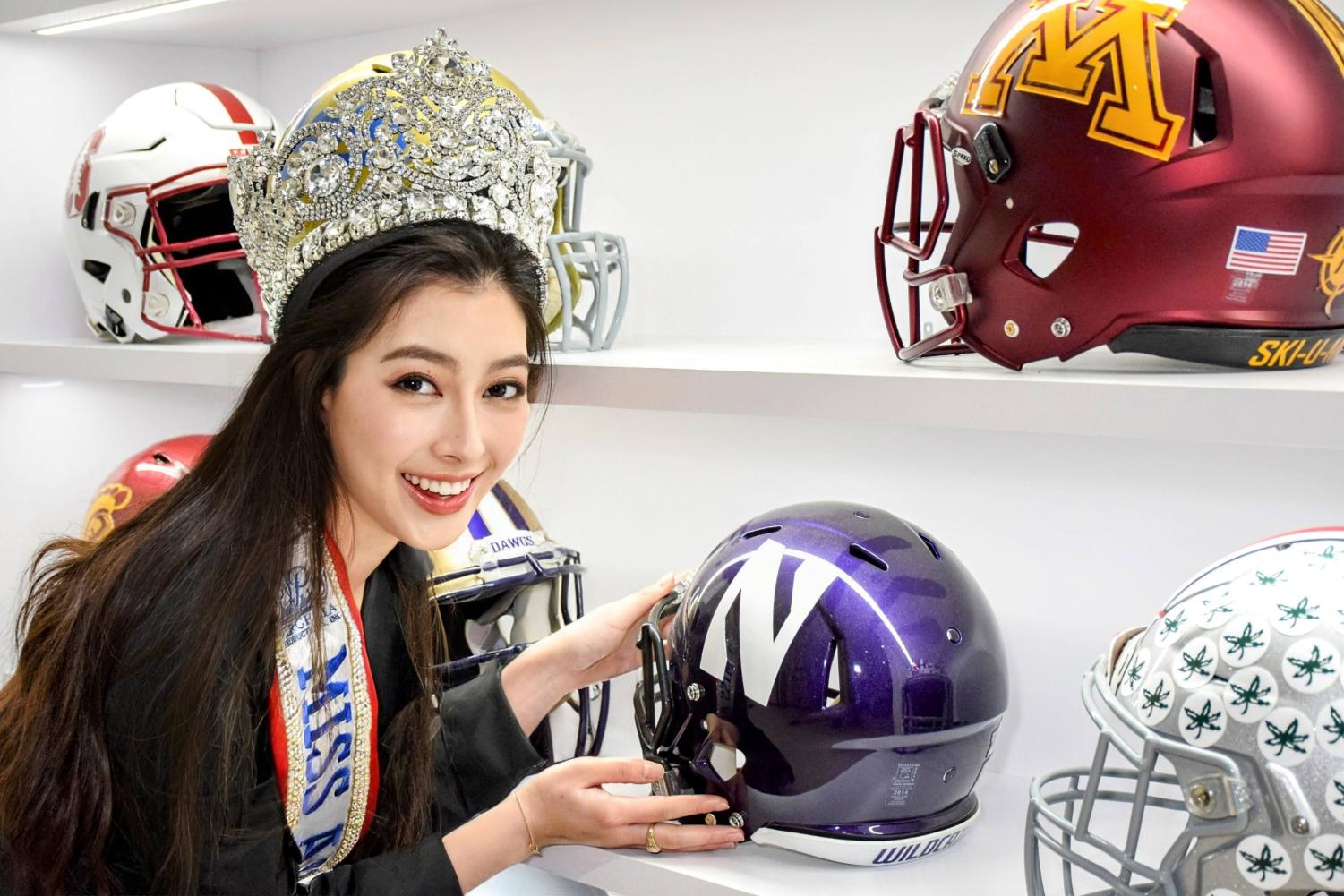 Girl+wearing+a+tiara+stands+next+to+a+Northwestern+football+helmet.