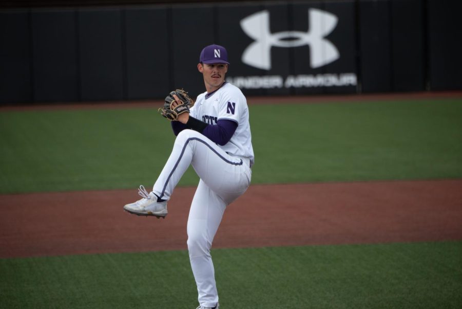 Man in white and purple uniform throws a baseball.