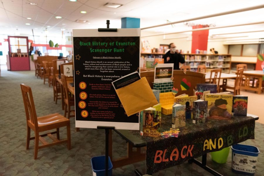 A poster titled “Black History of Evanston Scavenger Hunt” stands in front of a table titled “Black and Bold.”