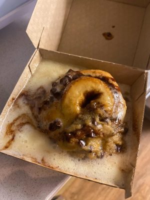 Cinnamon roll with melted icing and cookie dough