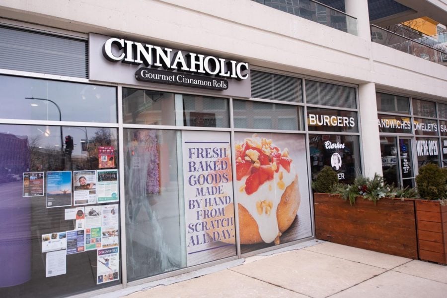 Cinnaholic storefront with glass windows and a photo of a cinnamon roll