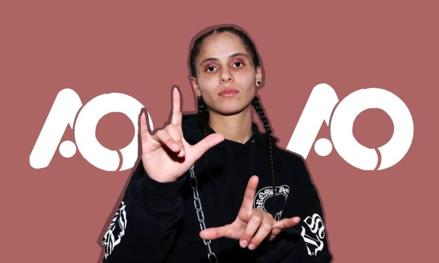 070 Shake with a black sweatshirt in front of a pink backdrop that reads A&O.