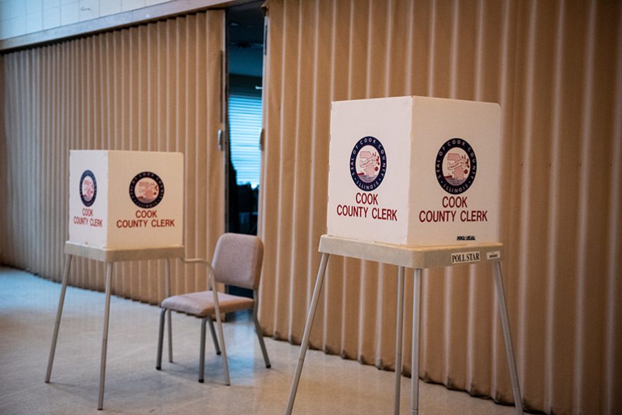 Two voting stations in front of a beige curtain