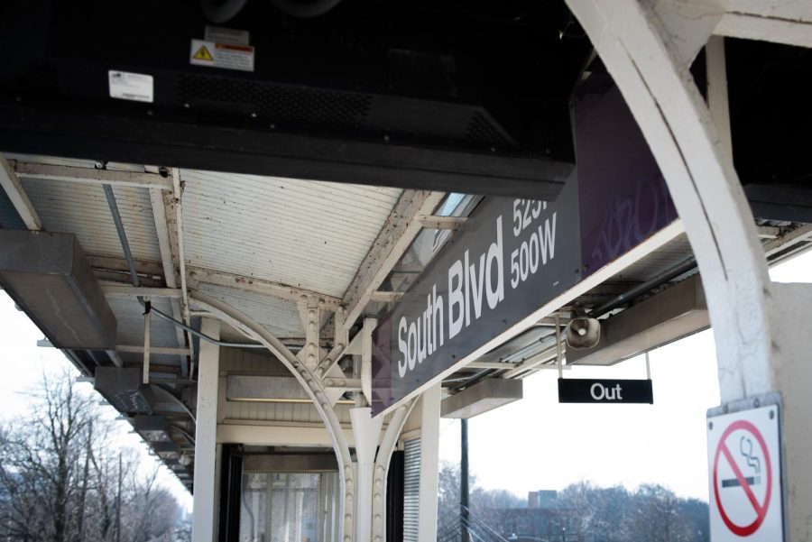 Overhead black sign of train platform that says, “South Blvd.”