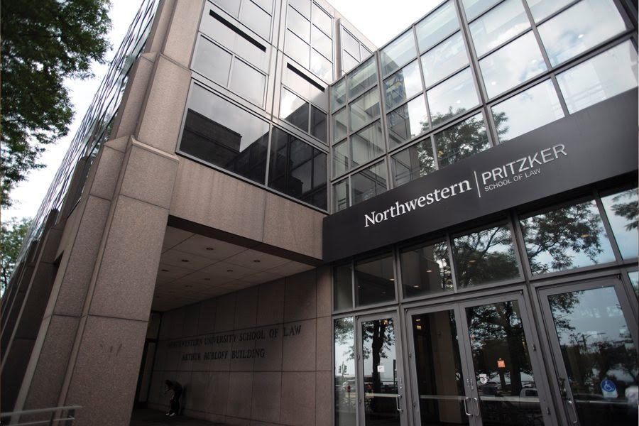 Image of building with glass windows and concrete pillars with the words “Northwestern, Pritzker School of Law.”