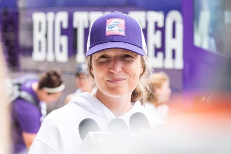 A woman in a white shirt and purple hat.